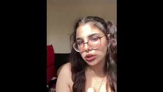 Attractive chick in pigtails licks her realistic dildo and salivates all over it