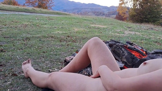Sweet outdours. Naked whore in nature. Fire and mountains