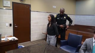 Handcuffed Woman taken away for DUI